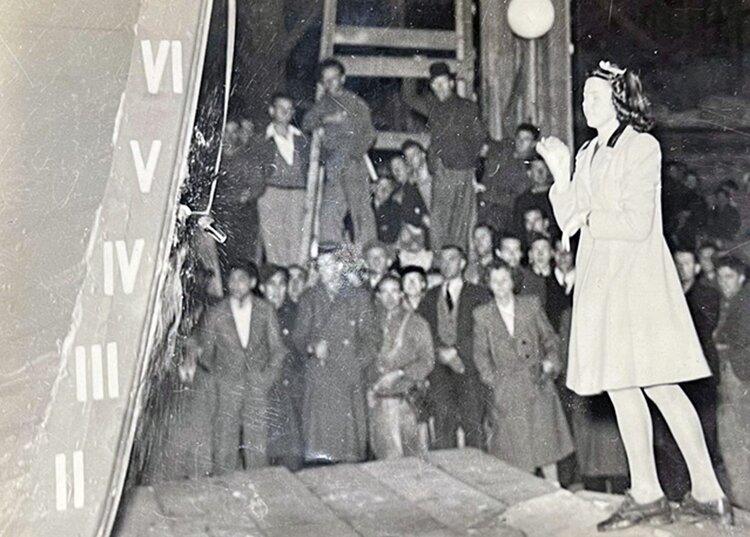Jocelyn Skinner (age 14) christening an American WW2 support vessel at the boat’s official launching, watched by the Percy Vos staff and families. The boat was launched on the first high tide after completion, at 11pm on 13th July 1944.